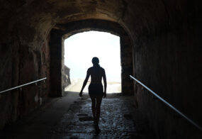 Woman walking through a tunnel